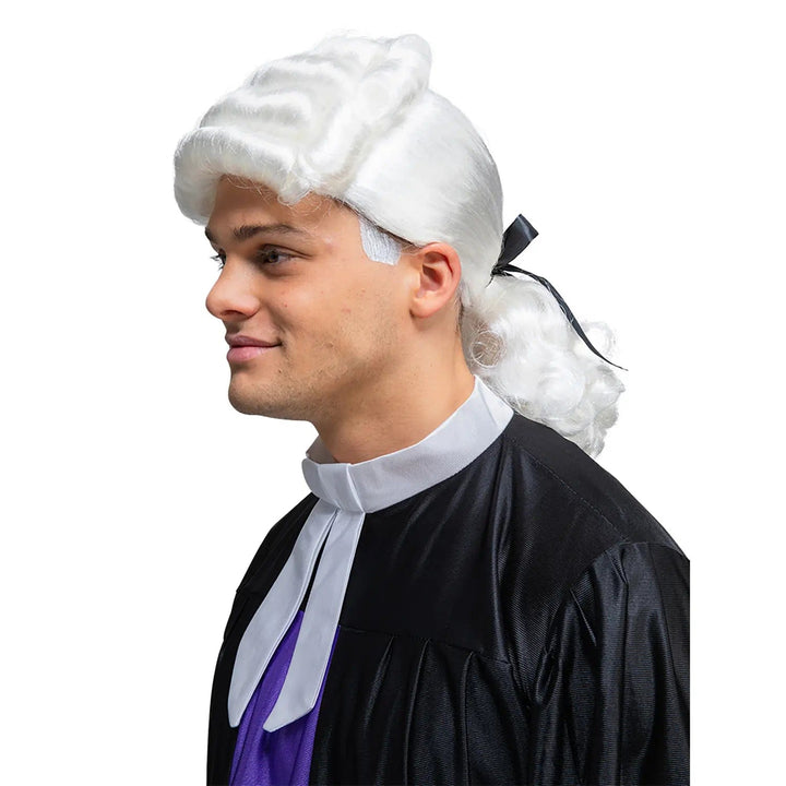 Side view of a man wearing a judge, colonial white hair wig for historical fancy dress costume