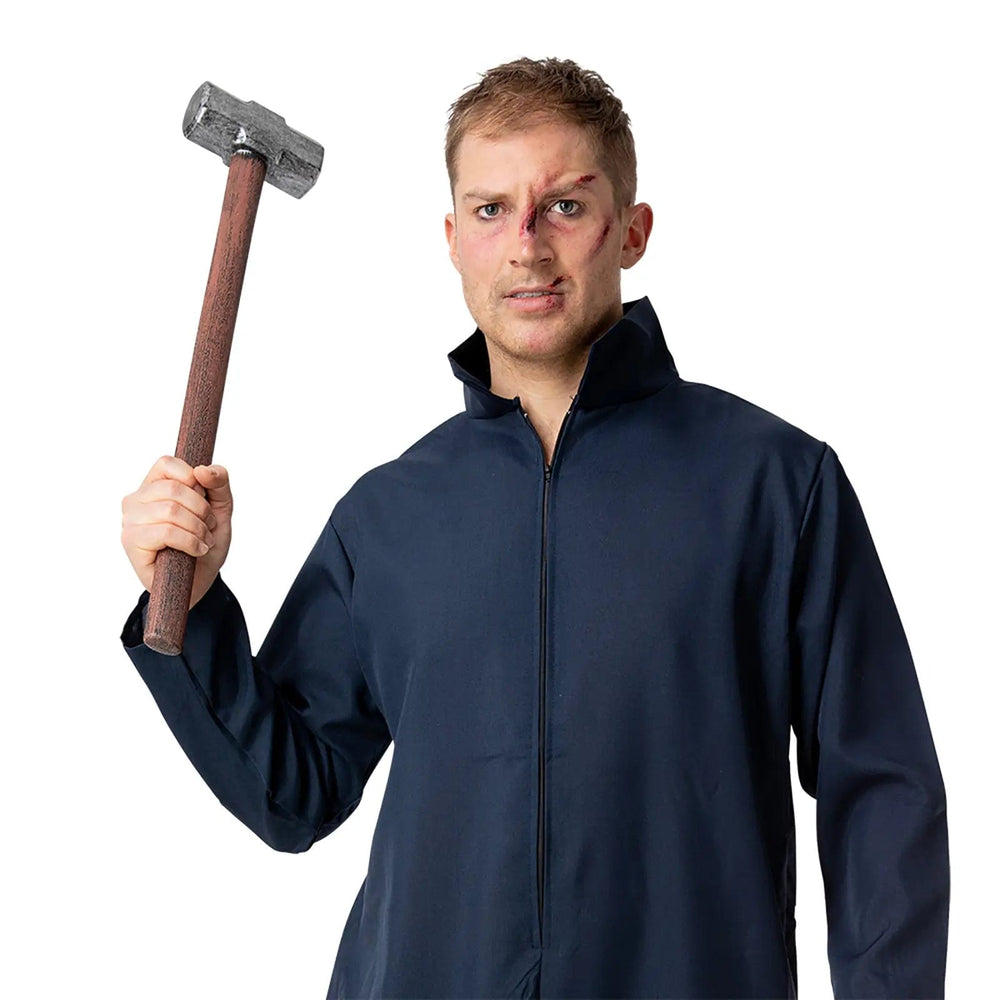 Man dressed in a blue boiler suit holding a plastic sledgehammer