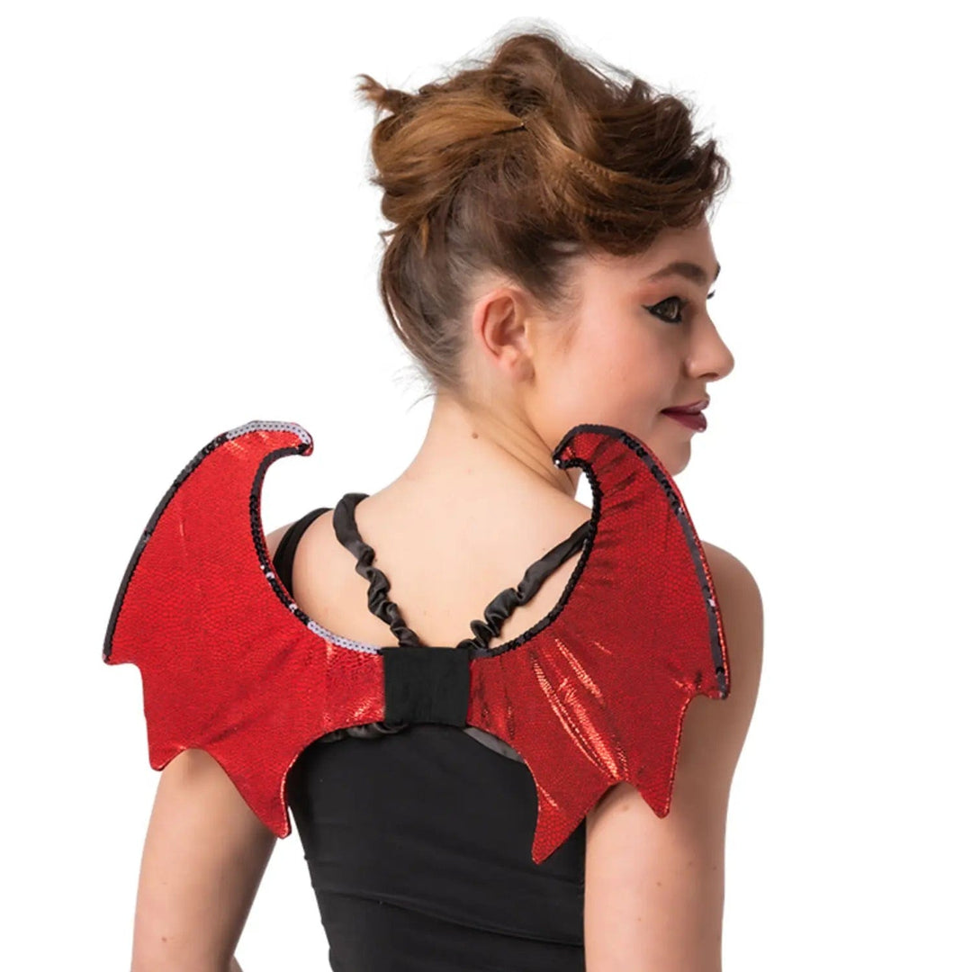 Woman wearing a pair of red shiny devil wings trimmed with black sequins for a Halloween party