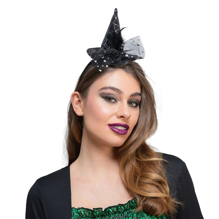 Lady wearing a mini witch hat with silver spider web, sequins and black rose with tulle netting