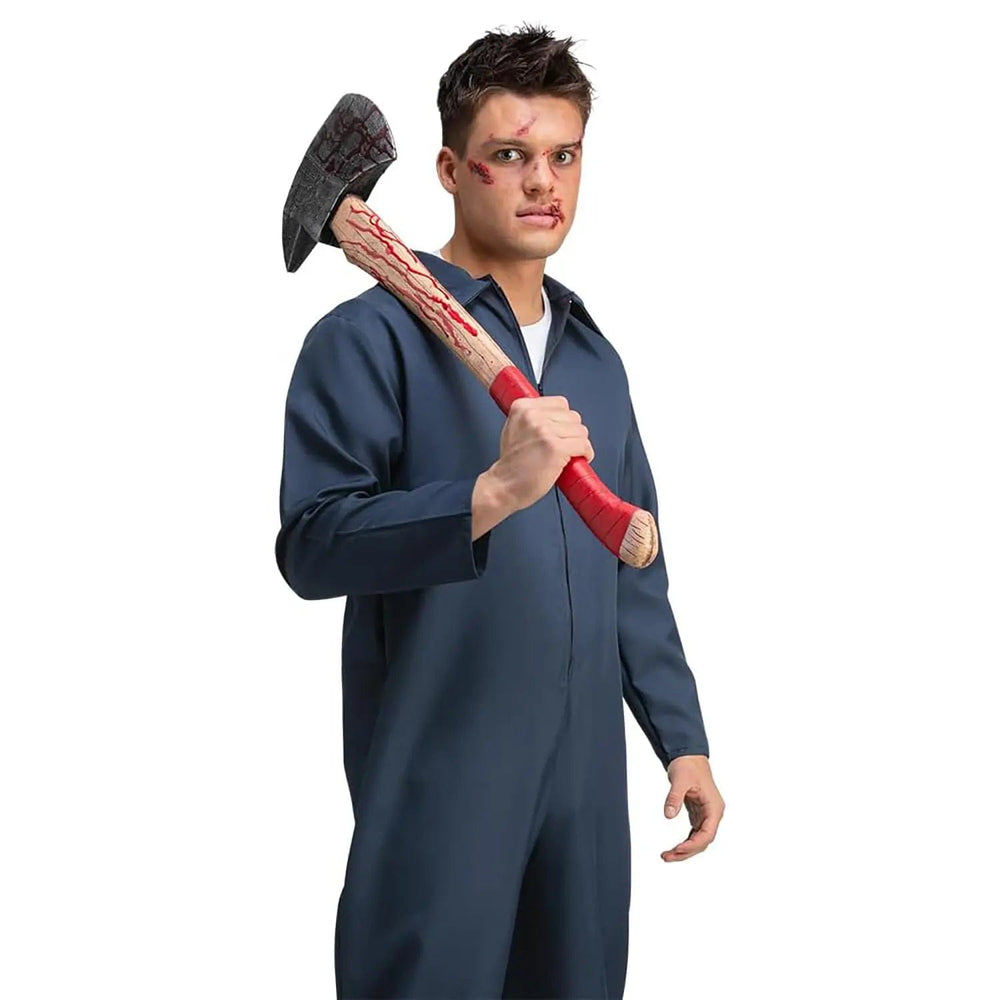 Man wearing a blue boiler suit holding a large fire axe