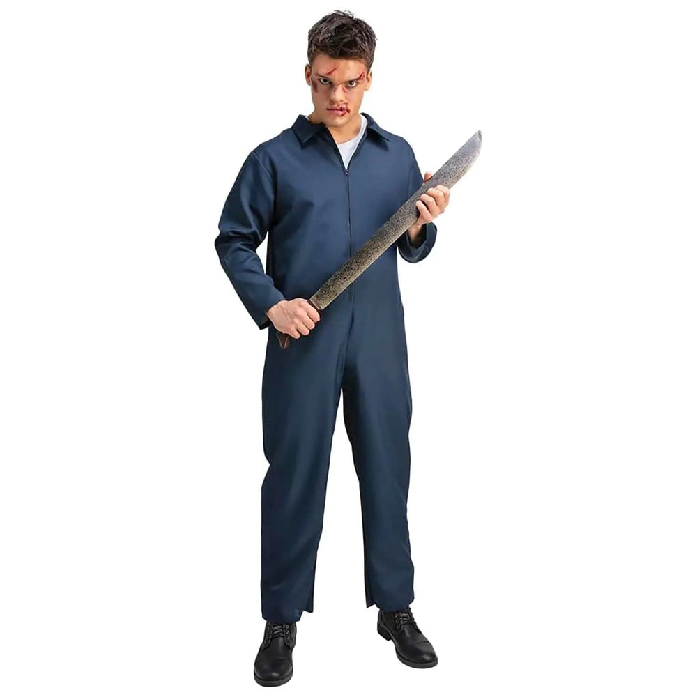 Man wearing a blue boiler suit holding a very large fake machete knife costume prop weapon