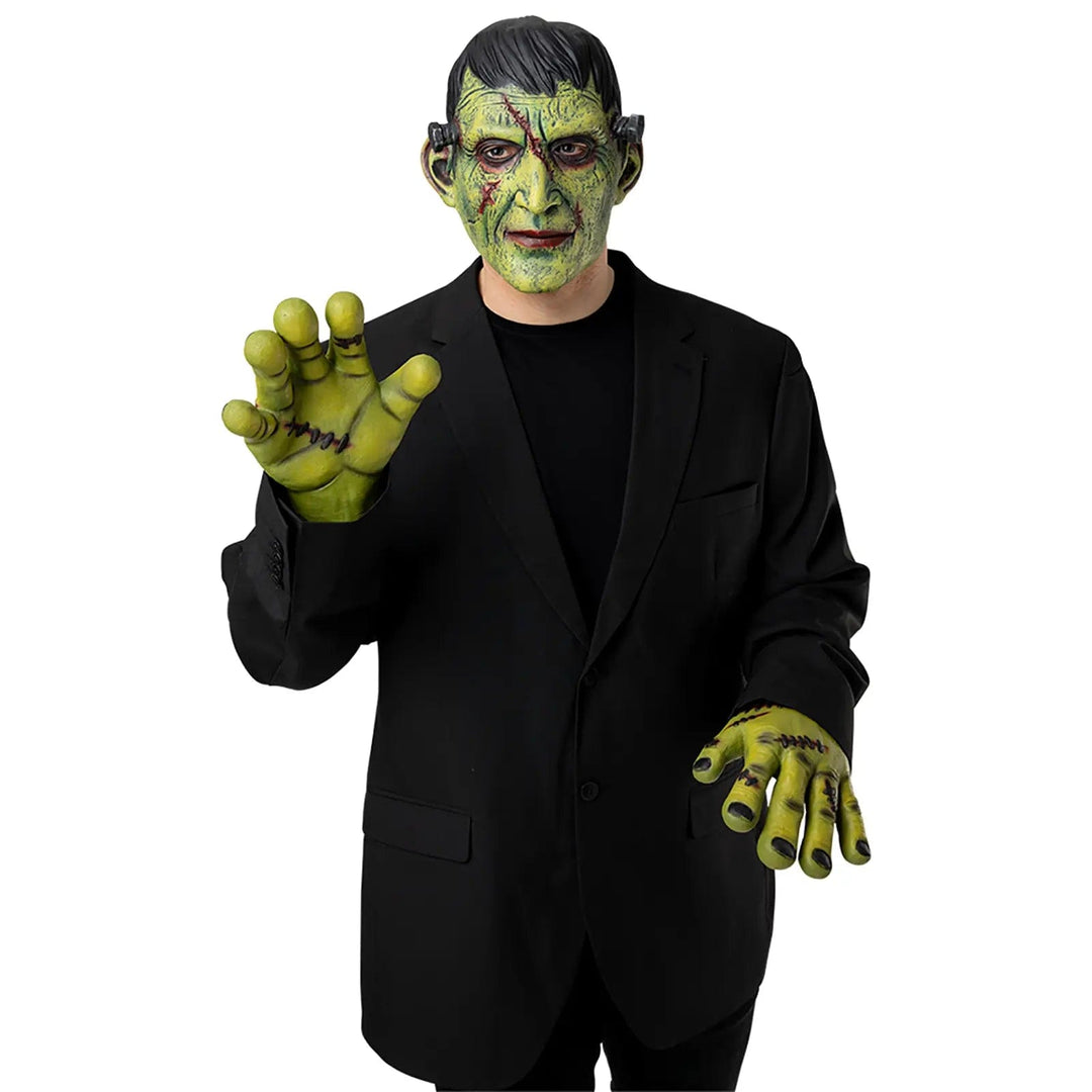 Person wearing a green monster mask and green hands for Halloween costumes