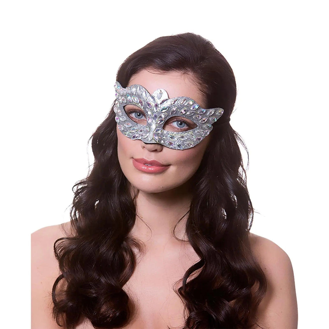 Lady with long dark hair wearing a silver diamante eye mask for fancy dress costumes and masquerade balls