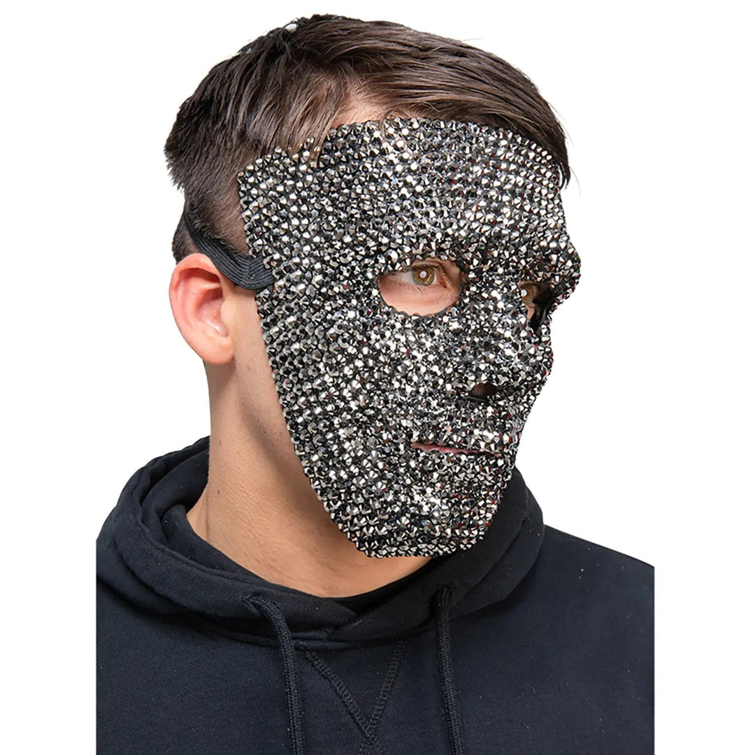 man wearing a diamante covered masquerade mask with black strap to secure