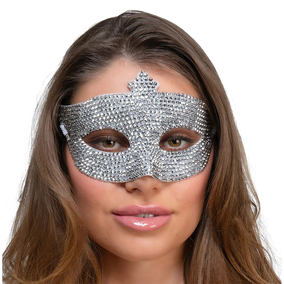 Woman wearing a masquerade mask decorated with sparkling diamante jewels