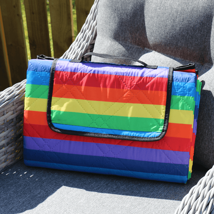 rainbow coloured picnic rug on grey garden furniture chair