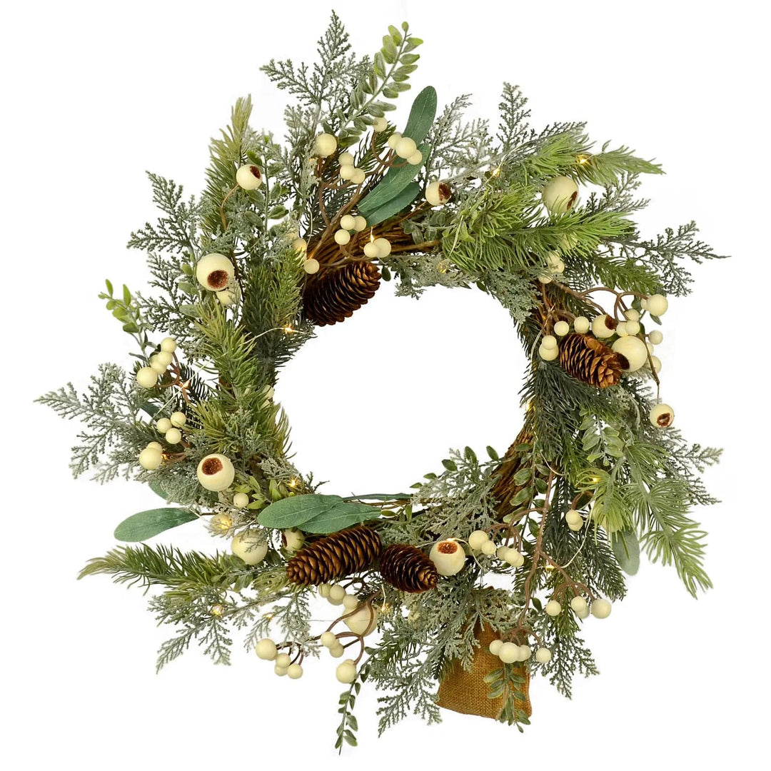 Christmas Wreath with mixed artificial green branches, snowberries and pine cones with warm white fairy lights