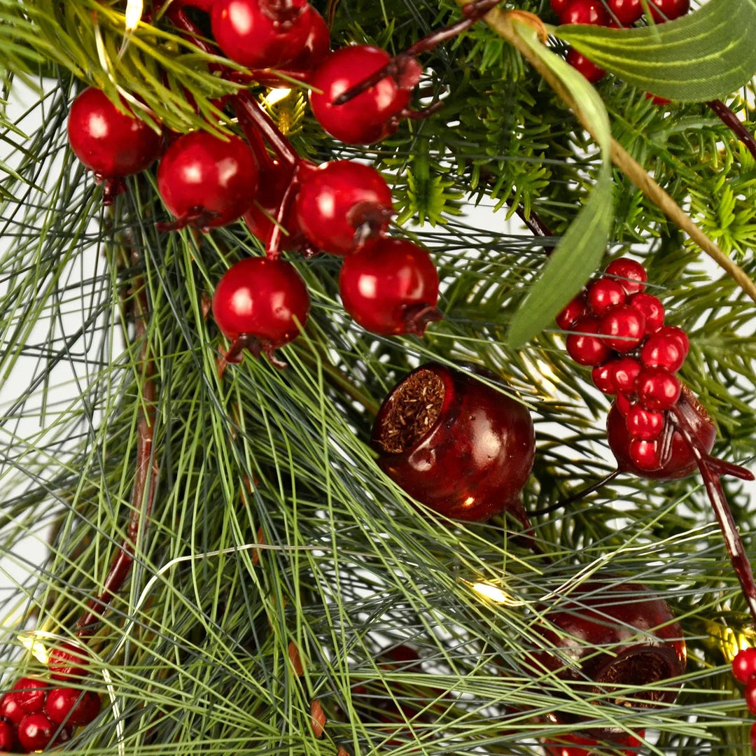 Close up of red berries and micro LED lights on a traditional Christmas wreath