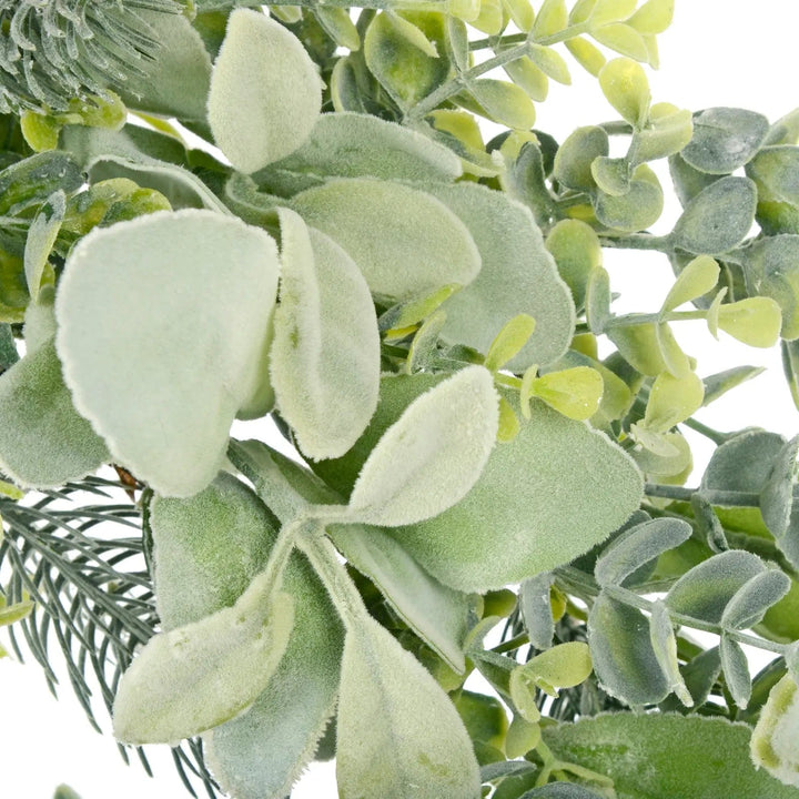 Close up of artificial velvety leaves on a green foliage festive wreath