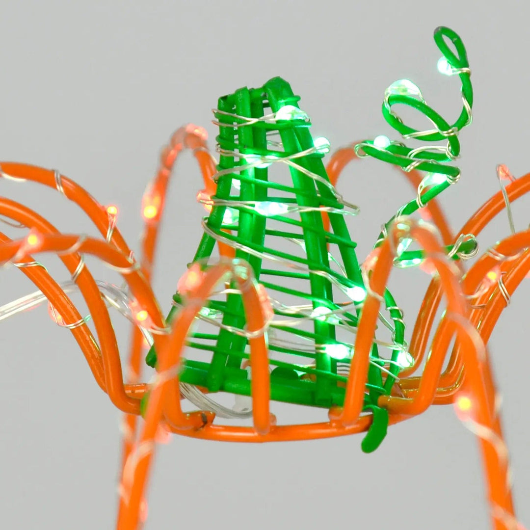 Close up of stalk on a halloween pumpkin decoration with green LED lights on the stalk