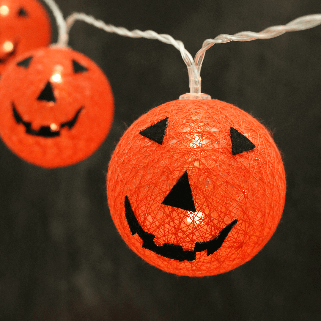 orange pumpkin string lights with warm white led lights on black background