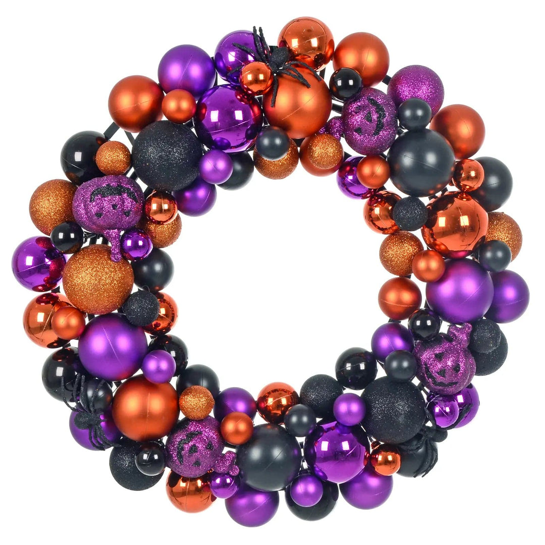 halloween door wreath with purple, orange and black baubles, purple pumpkins and black glittering spiders