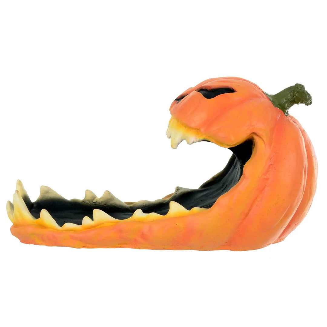 Side view of a large orange pumpkin candy tray with big teeth