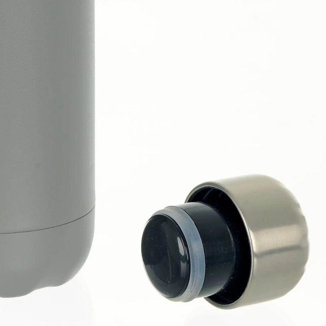 Close up of silver stainless steel screw on cap of insulated water bottle in grey