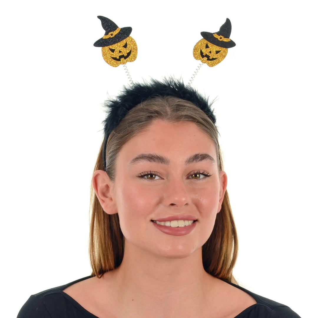 Young lady wearing a pair of gold glitter pumpkin head bopper with black fluffy headband for Halloween fancy dress parties