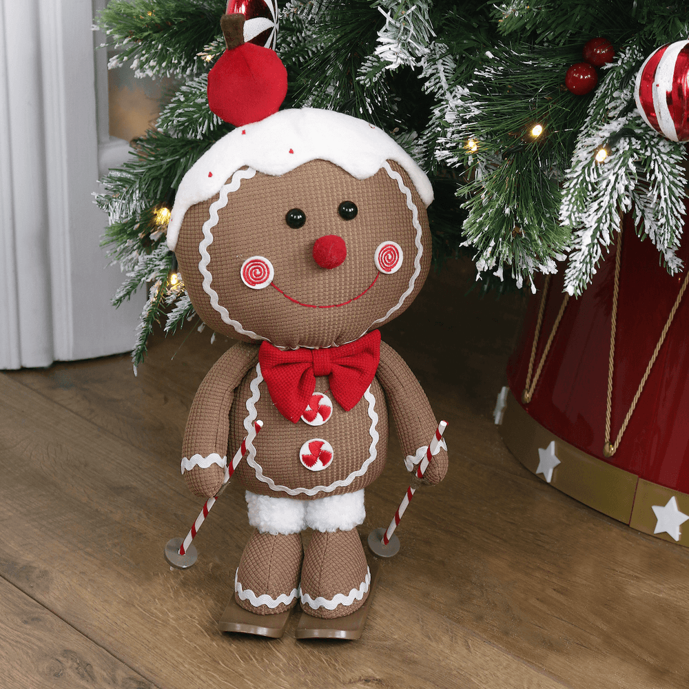 cute gingerbread figure in front of christmas tree