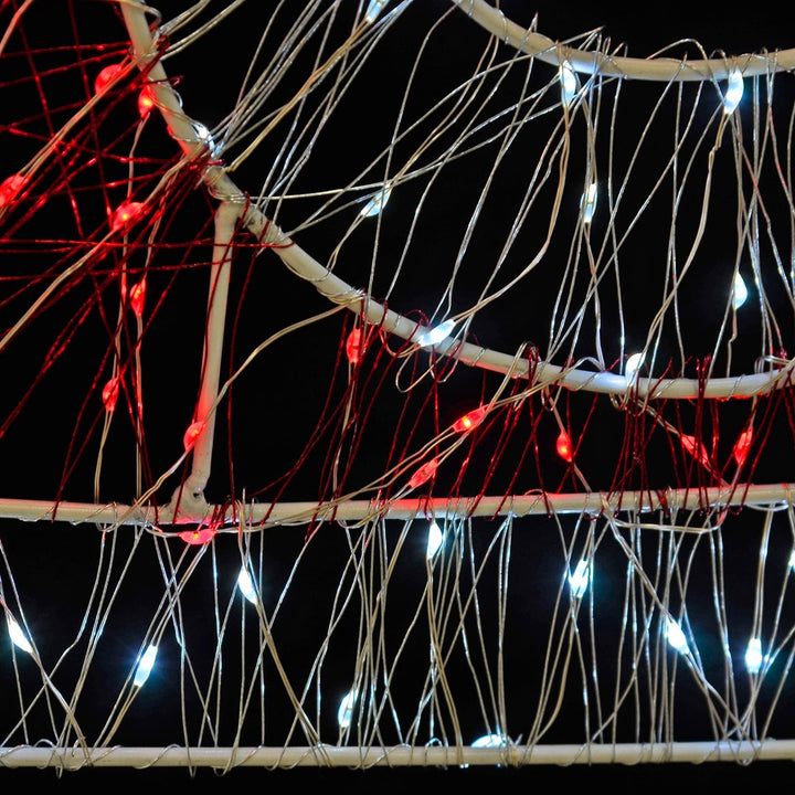 Close up detail of LED microlights in red and white with copper wire wound round a white frame