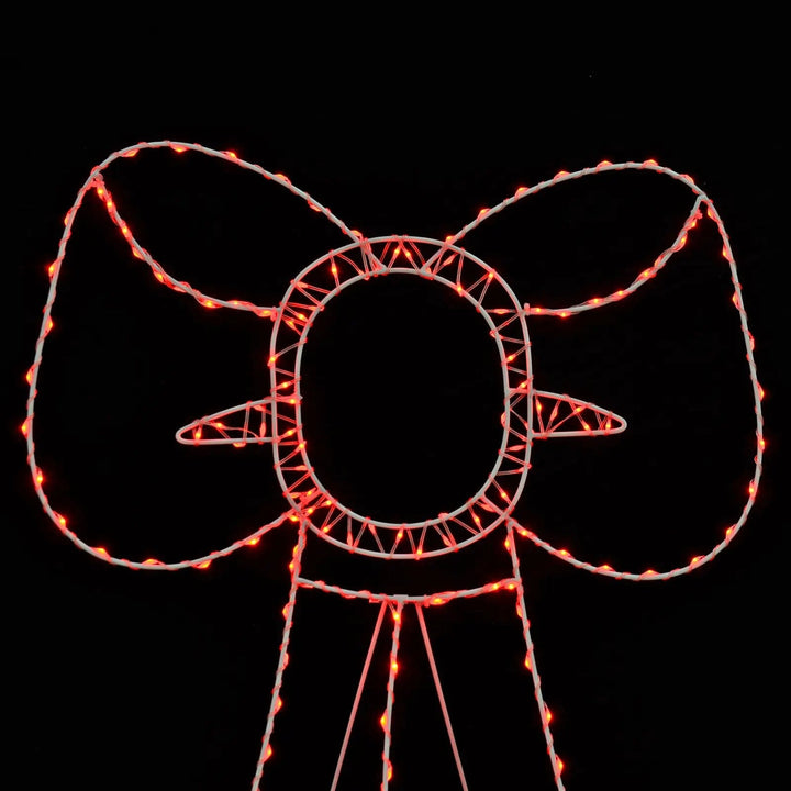 Red LED lights on a white frame bow Christmas silhouette light for use outdoors