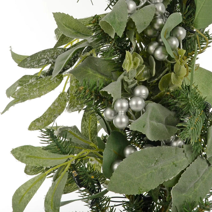 Close up of silver berries and green leaves on a Christmas garland