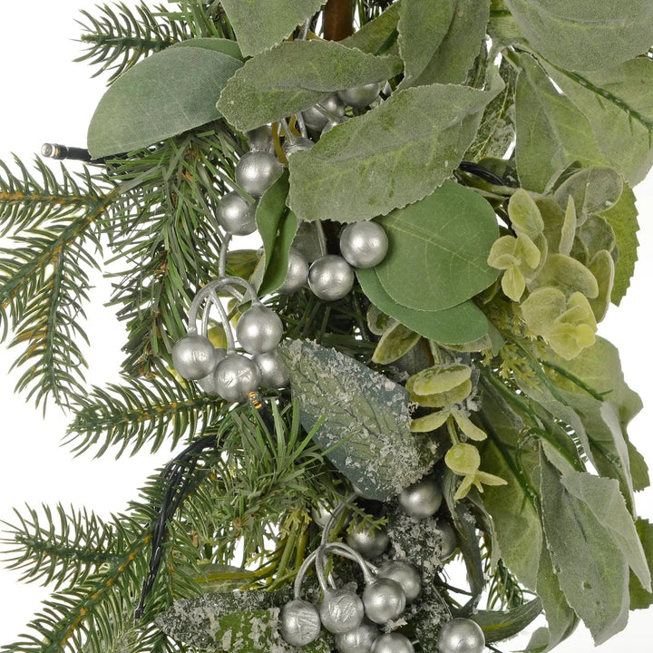 Silver berries, LED lights and frosted green foliage on a Christmas garland