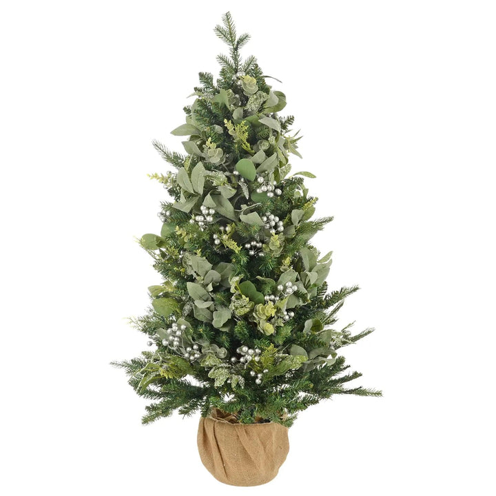 Green foliage small Christmas tree with eucalyptus branches and silver berries, with a jute base