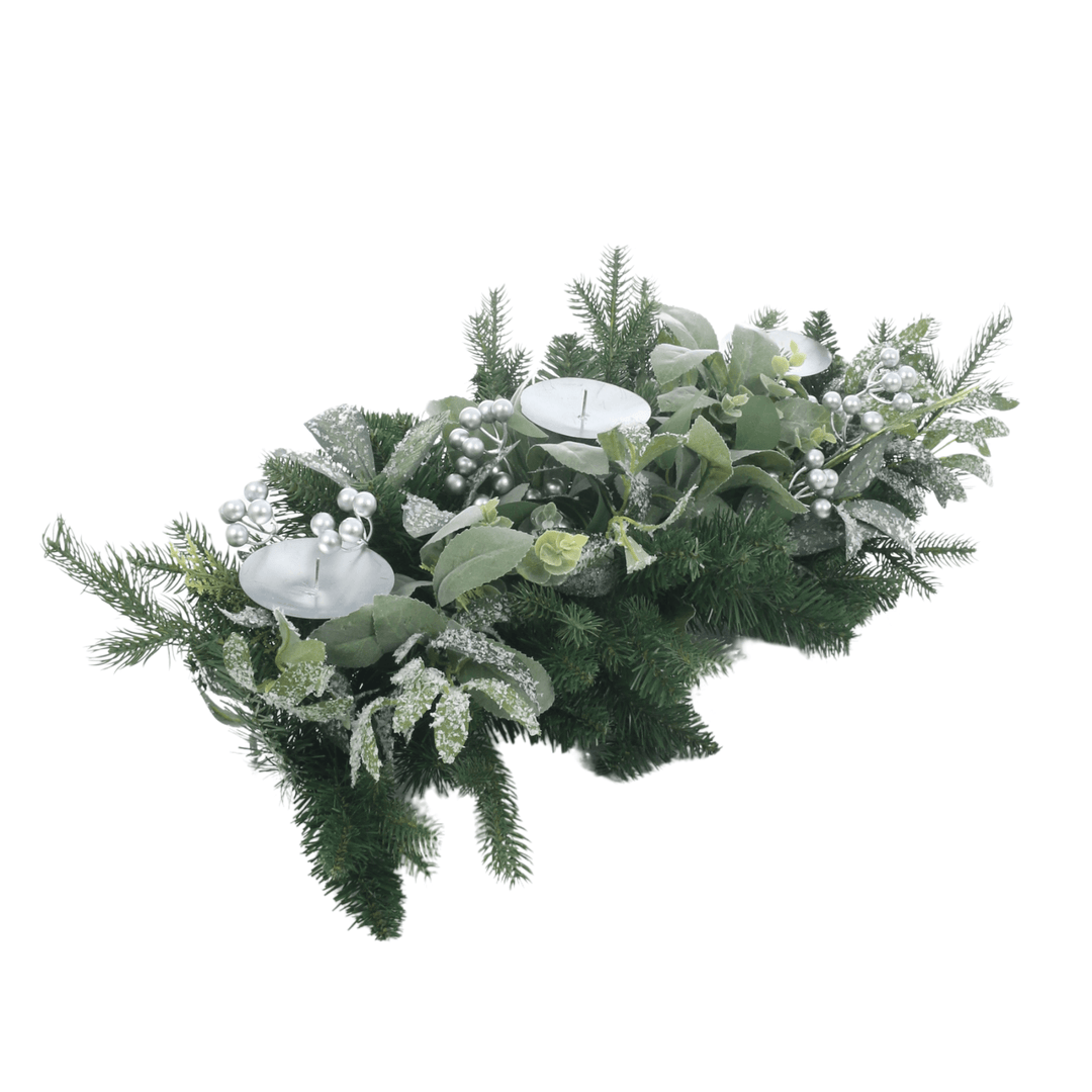 side view of table centrepiece with pine branches, leaves and silver berries