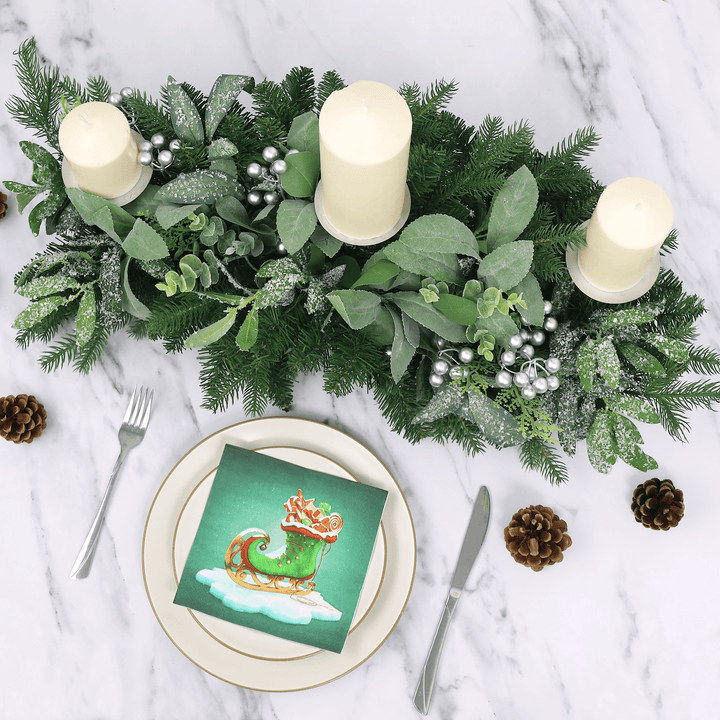 top view of table centre piece on marble table with plate set up featuring green napkin