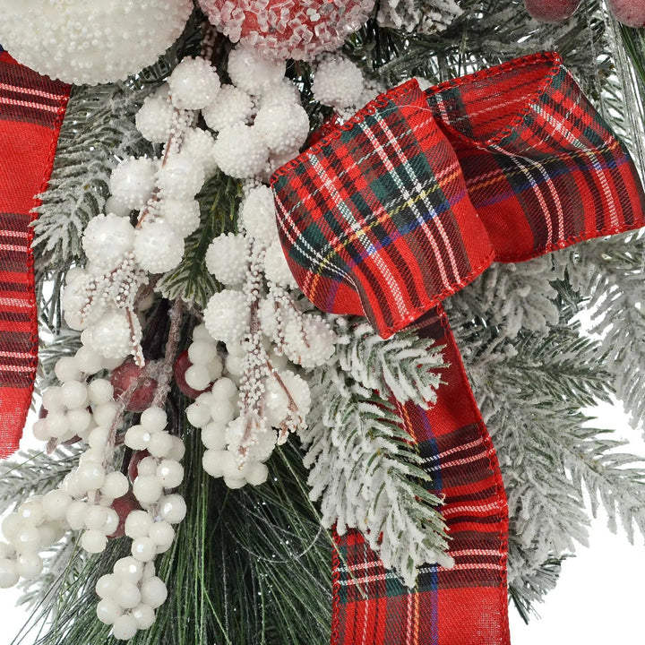 Red tartan ribbon and white berries on a mini Christmas tree