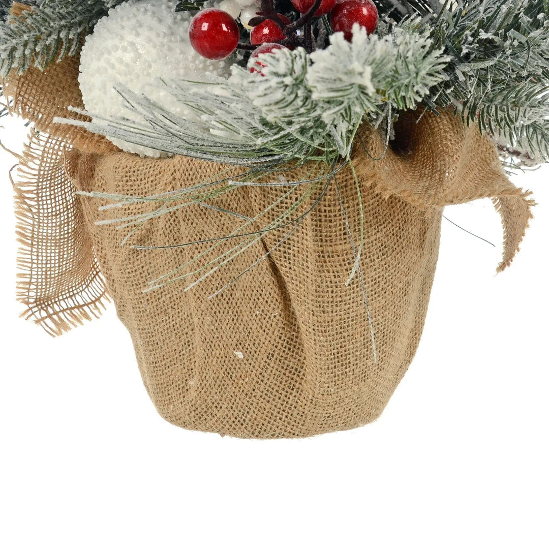 Jute base on a mini artificial Christmas tree with red berries and frosted branches