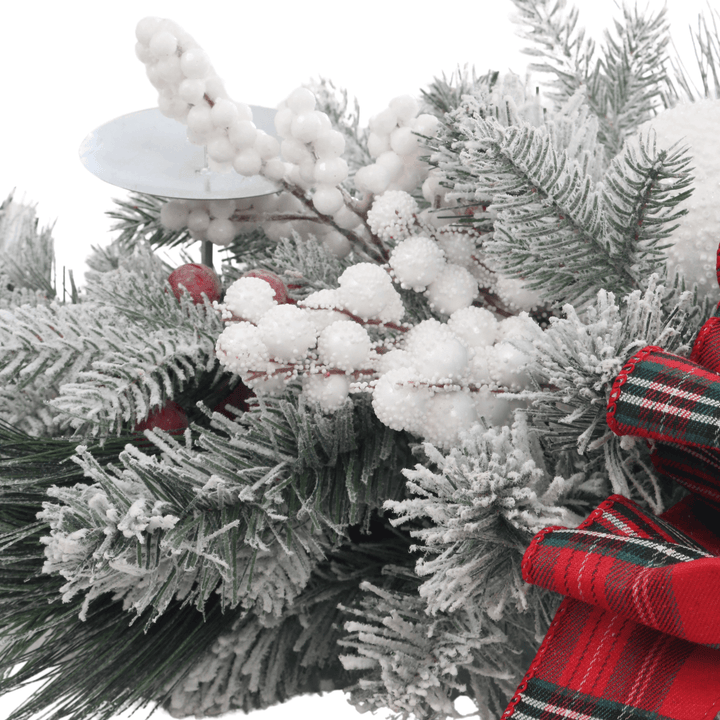 detail shot of show covered berries and flocked pine branches