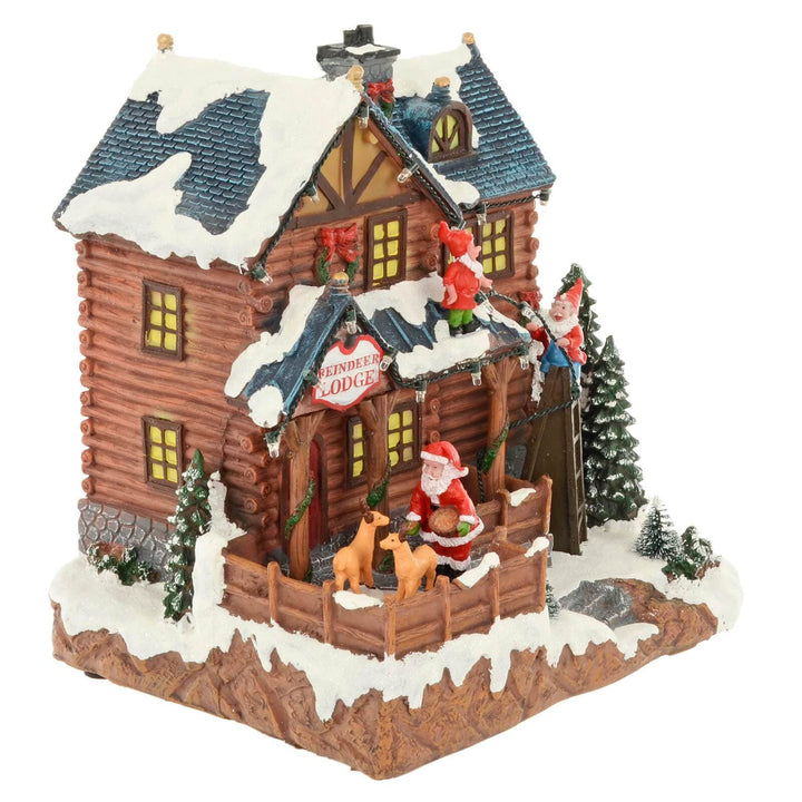 Christmas Reindeer Lodge Snow Scene Light Up Music Moving 24cm